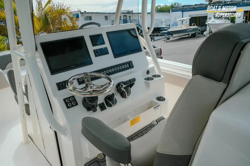 Slide: The Image of 2026 Key West 291 FS boat dashboard with modern controls and dual screens. - 13