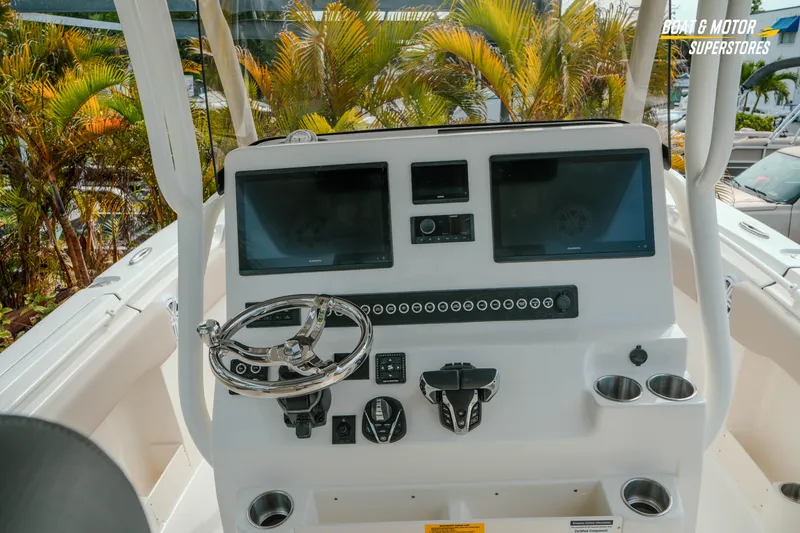 Slide: The Image of 2026 Key West 291 FS boat dashboard with dual screens and steering wheel. - 15