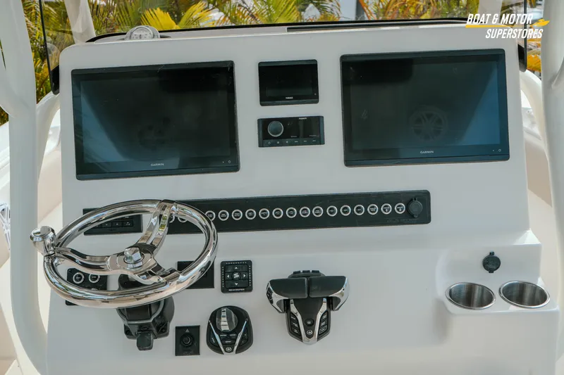 Slide: The Image of 2026 Key West 291 FS boat dashboard with dual Garmin displays and modern controls. - 16