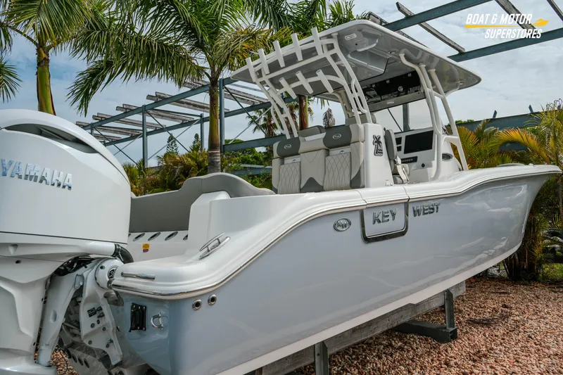 Slide: The Image of 2026 Key West 291 FS boat with Yamaha engine, displayed outdoors near palm trees. - 3