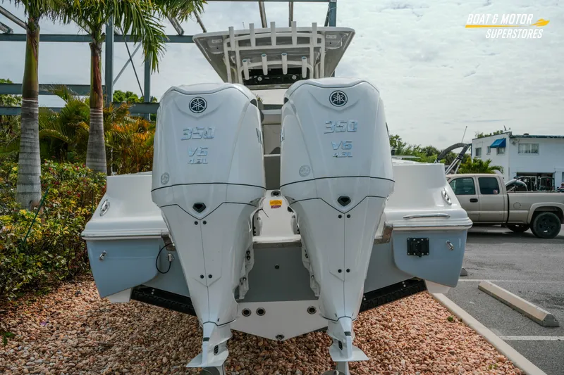 Slide: The Image of 2026 Key West 291 FS boat with dual Yamaha 350 V6 engines, parked outdoors. - 5