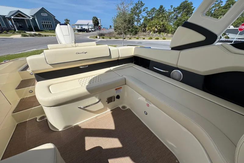 Slide: The Image of 2026 Chris-Craft Sportster 28 boat interior with beige seating and modern design. - 12