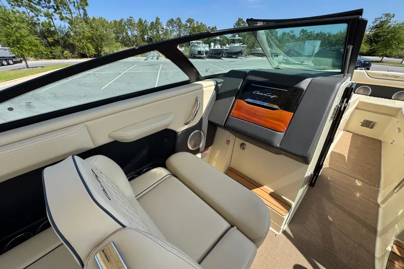 Slide: The Image of 2026 Chris-Craft Sportster 28 interior with beige seating and modern dashboard design. - 13