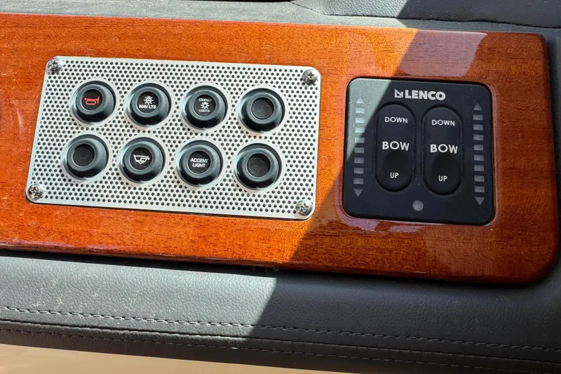 Slide: The Image of Control panel of 2026 Chris-Craft Sportster 28 boat with Lenco trim tab switches. - 16