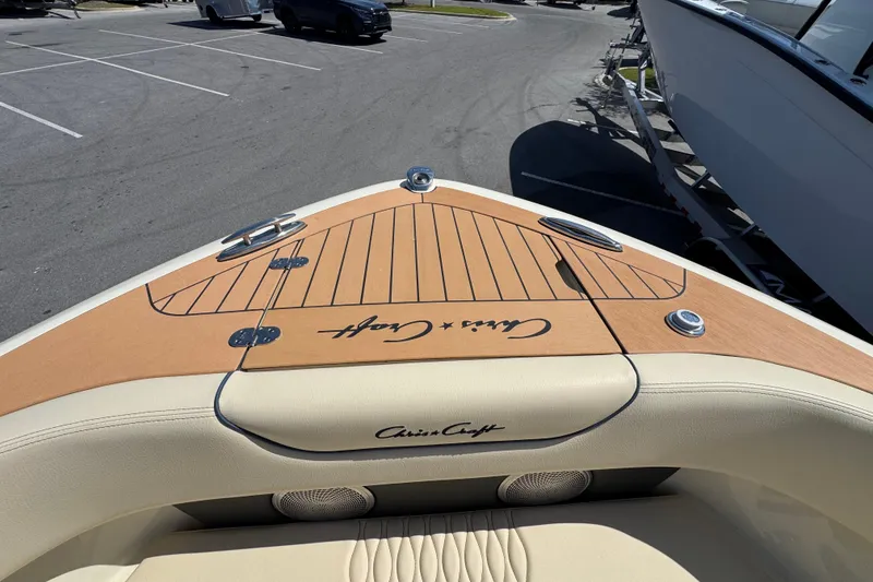 Slide: The Image of 2026 Chris-Craft Sportster 28 boat bow with teak deck and signature logo. - 20