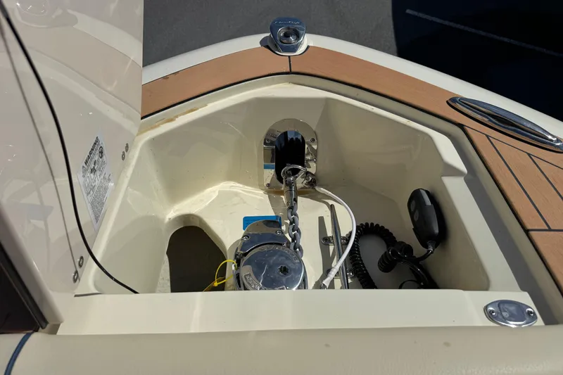 Slide: The Image of Anchor compartment of 2026 Chris-Craft Sportster 28 boat with chain and winch. - 21