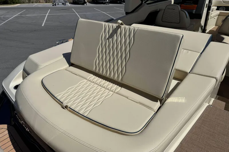 Slide: The Image of 2026 Chris-Craft Sportster 28 boat with luxurious beige seating in a parking lot. - 9