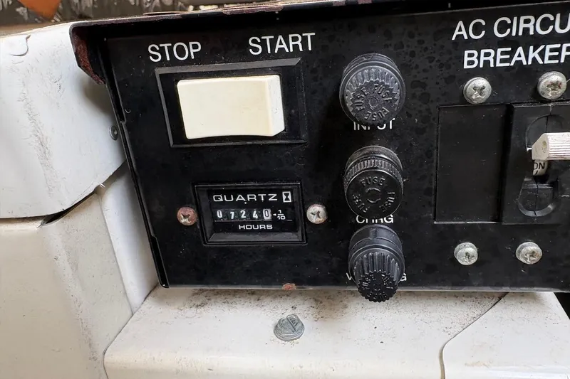 Slide: The Image of Control panel of a 2006 Larson Cabrio 260 boat, showing hour meter and switches. - 10