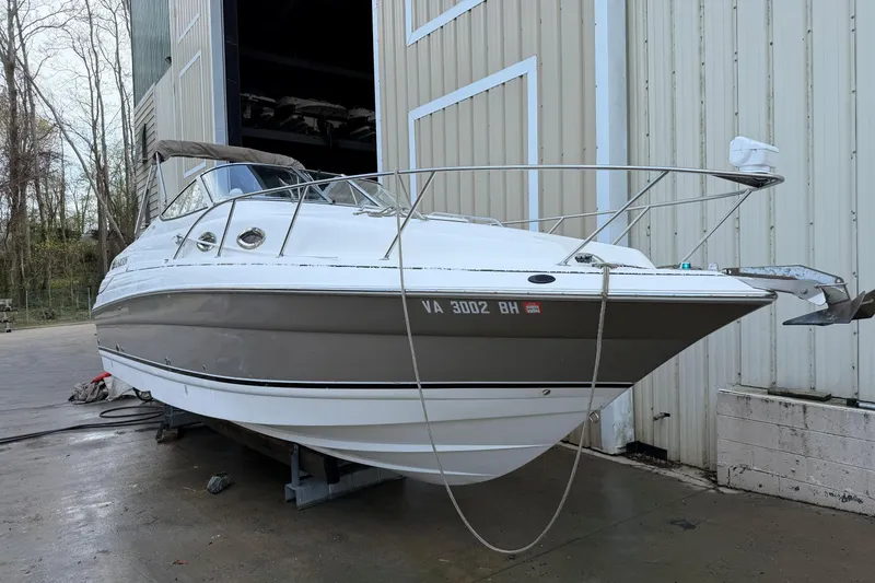 Slide: The Image of 2006 Larson Cabrio 260 boat docked outside a storage facility. - 16