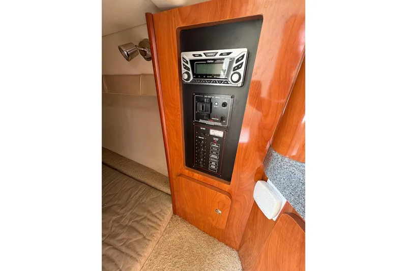 Slide: The Image of 2006 Larson Cabrio 260 cabin interior with control panel and stereo system. - 3