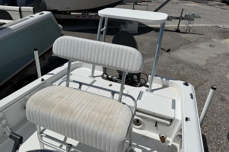 Slide: The Image of 2010 Sea Hunt XP 19 boat interior with white seating and console. - 2