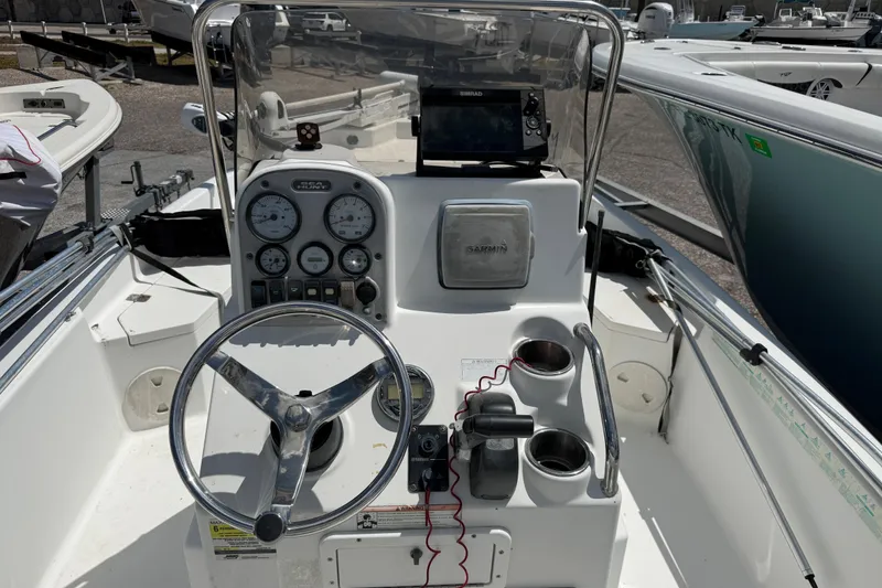 Slide: The Image of 2010 Sea Hunt XP 19 boat dashboard with steering wheel and navigation instruments. - 3