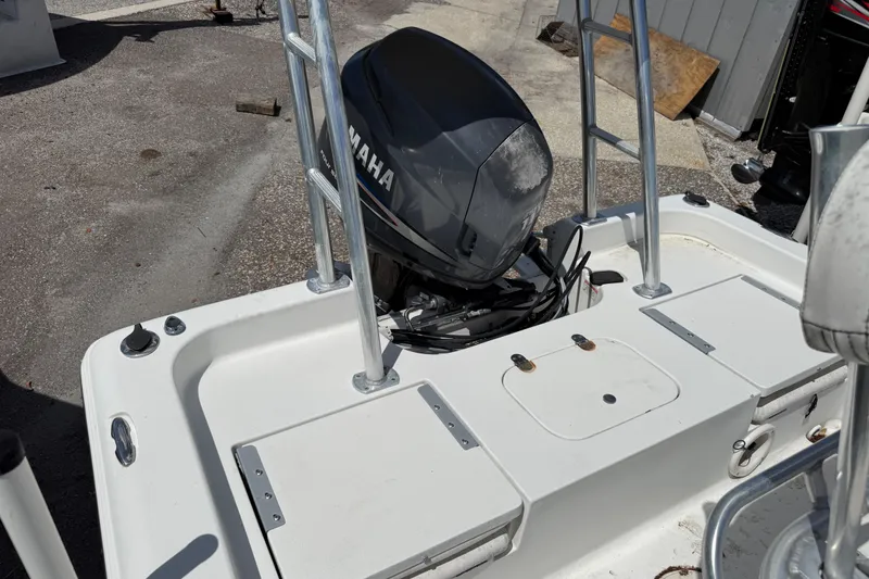 Slide: The Image of 2010 Sea Hunt XP 19 boat with Yamaha outboard motor, docked on concrete surface. - 4