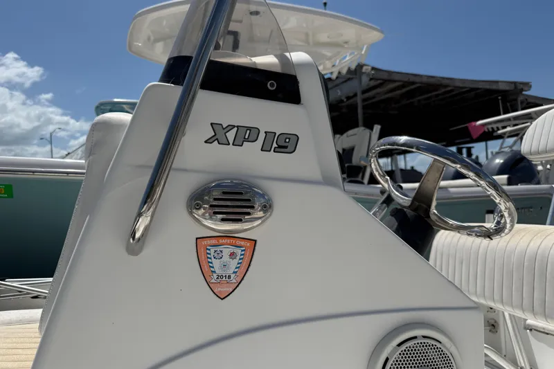 Slide: The Image of 2010 Sea Hunt XP 19 boat console with steering wheel and safety check sticker. - 8