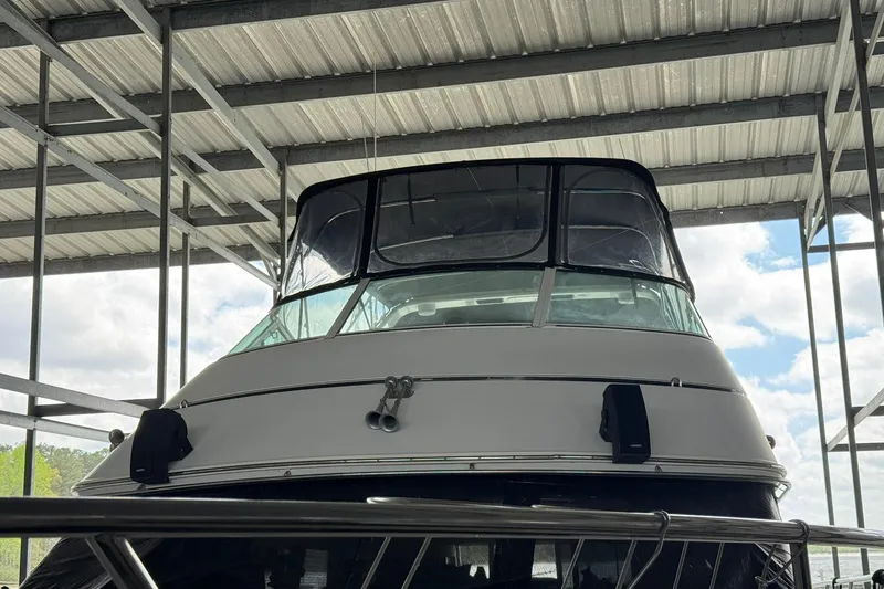 Slide: The Image of 1999 Carver 450 Voyager Pilothouse yacht docked under a metal roof. - 10
