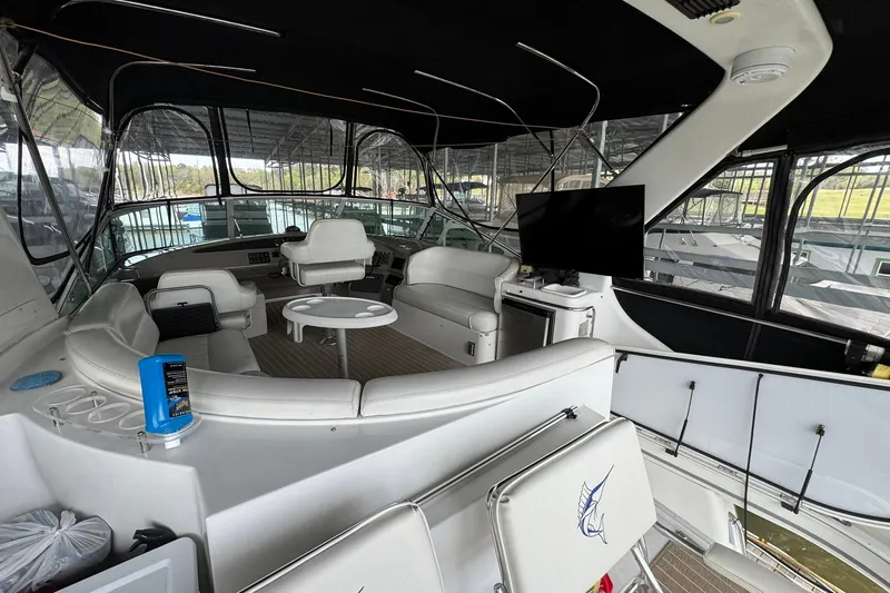 Slide: The Image of Luxurious interior of 1999 Carver 450 Voyager Pilothouse yacht with seating and TV. - 16