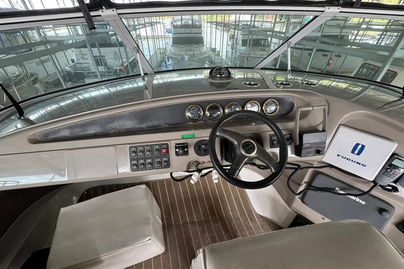 Slide: The Image of 1999 Carver 450 Voyager Pilothouse helm with navigation equipment and controls. - 23