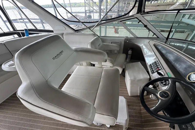 Slide: The Image of Interior of 1999 Carver 450 Voyager Pilothouse with helm and seating area. - 25