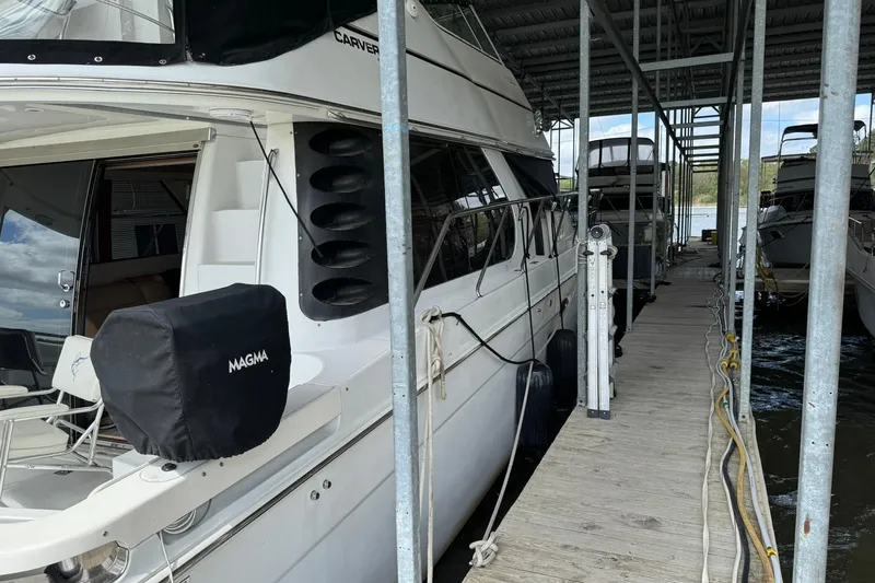 Slide: The Image of 1999 Carver 450 Voyager Pilothouse docked in a marina, side view. - 3