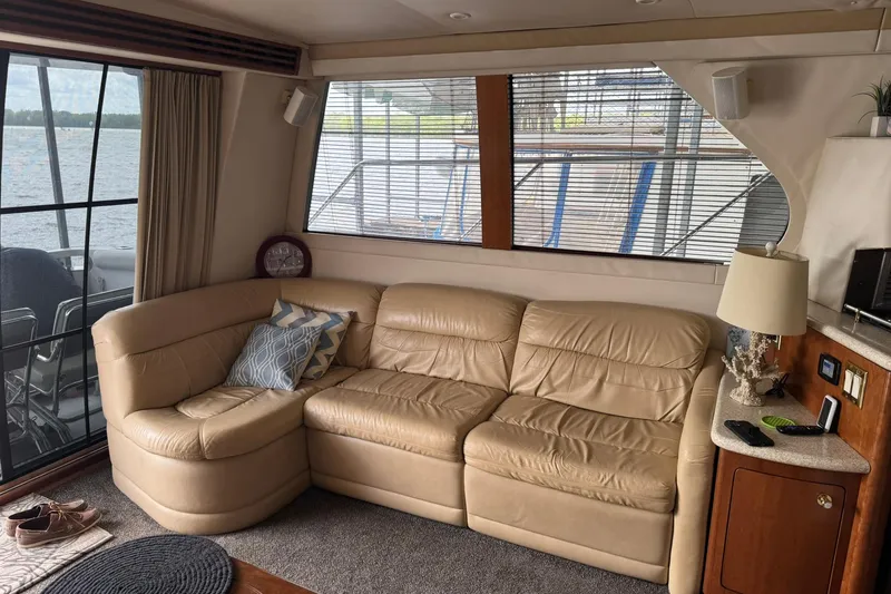 Slide: The Image of Interior of 1999 Carver 450 Voyager Pilothouse with beige leather sofa and nautical decor. - 30