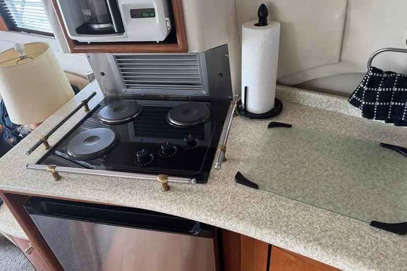 Slide: The Image of 1999 Carver 450 Voyager Pilothouse kitchen with stove, countertop, and appliances. - 32