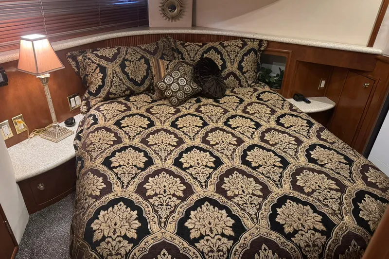 Slide: The Image of Luxurious bedroom interior of 1999 Carver 450 Voyager Pilothouse with ornate bedding. - 37