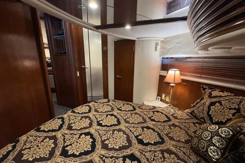 Slide: The Image of Luxurious bedroom interior of 1999 Carver 450 Voyager Pilothouse yacht with elegant bedding. - 38
