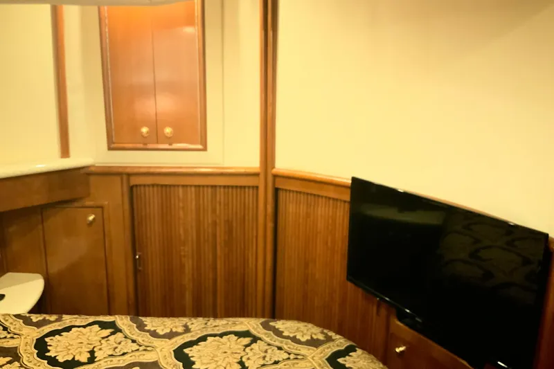 Slide: The Image of Interior of 1999 Carver 450 Voyager Pilothouse with wood paneling and mounted TV. - 41