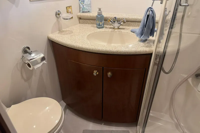 Slide: The Image of Bathroom interior of 1999 Carver 450 Voyager Pilothouse with sink, toilet, and shower. - 47