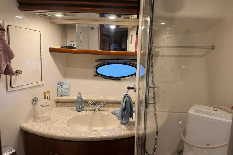 Slide: The Image of Bathroom interior of 1999 Carver 450 Voyager Pilothouse yacht, featuring sink and shower. - 48
