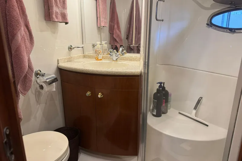 Slide: The Image of Bathroom in 1999 Carver 450 Voyager Pilothouse with shower, sink, and toiletries. - 49