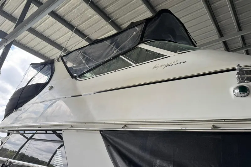 Slide: The Image of 1999 Carver 450 Voyager Pilothouse yacht under a metal canopy. - 5