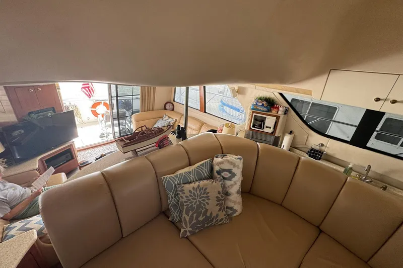 Slide: The Image of Interior of 1999 Carver 450 Voyager Pilothouse with cozy seating and nautical decor. - 52