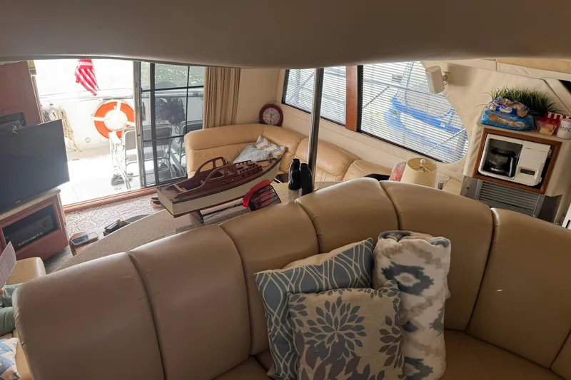 Slide: The Image of Luxurious interior of 1999 Carver 450 Voyager Pilothouse with plush seating and nautical decor. - 53