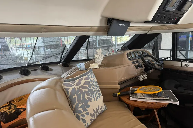 Slide: The Image of Interior of 1999 Carver 450 Voyager Pilothouse with helm, seating, and nautical decor. - 54