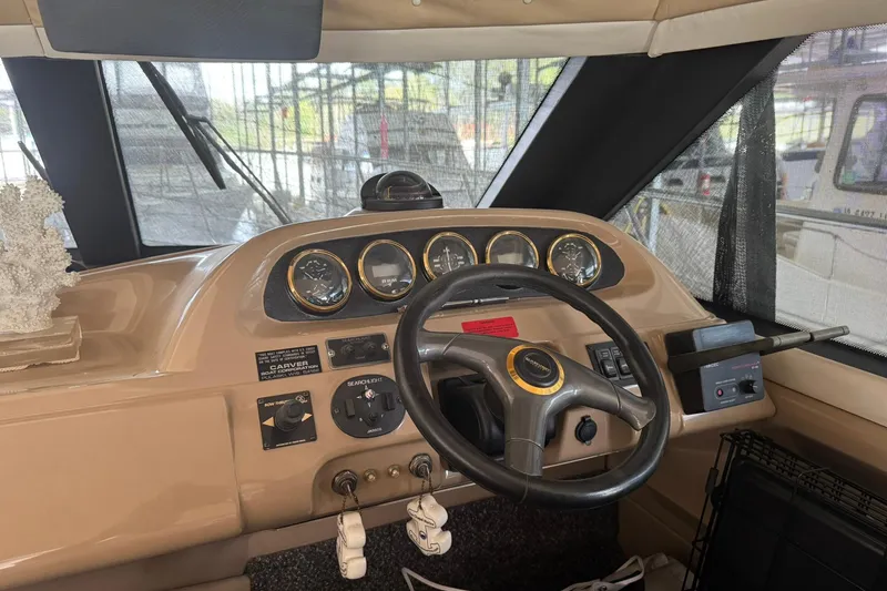 Slide: The Image of 1999 Carver 450 Voyager Pilothouse helm with steering wheel and instrument panel. - 56