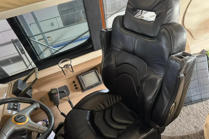 Slide: The Image of Luxurious black leather captain's chair in 1999 Carver 450 Voyager Pilothouse cockpit. - 57