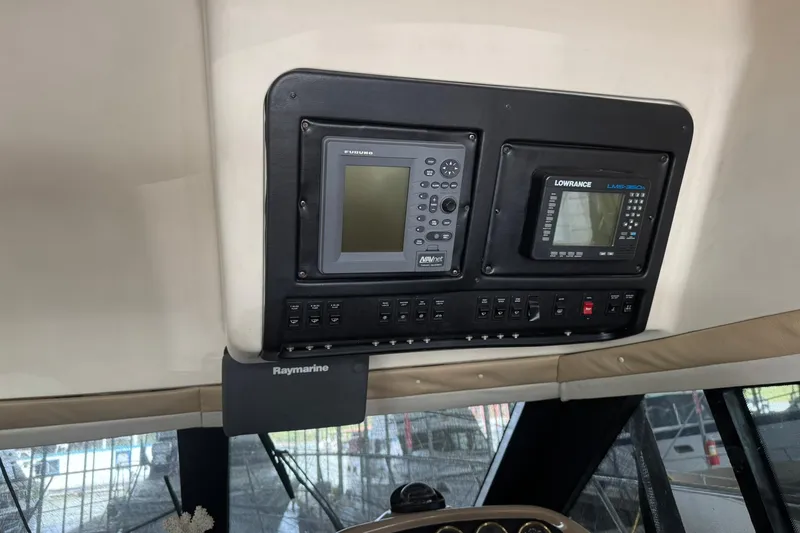 Slide: The Image of 1999 Carver 450 Voyager Pilothouse dashboard with navigation equipment and controls. - 58
