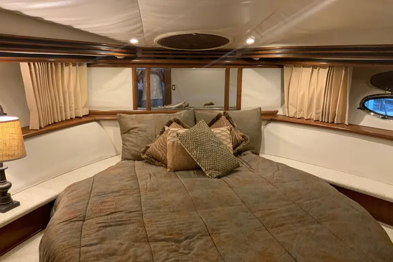 Slide: The Image of Luxurious bedroom interior of 1999 Carver 450 Voyager Pilothouse yacht with cozy bedding. - 59