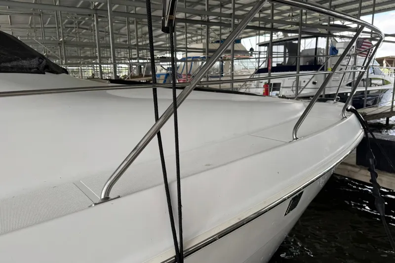 Slide: The Image of 1999 Carver 450 Voyager Pilothouse yacht docked in a marina. - 6