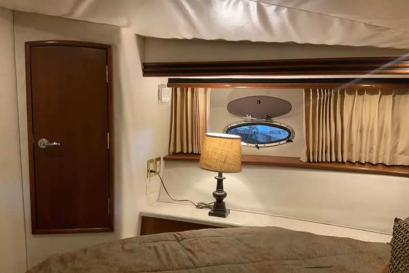 Slide: The Image of Cozy interior of 1999 Carver 450 Voyager Pilothouse with lamp and porthole window. - 61
