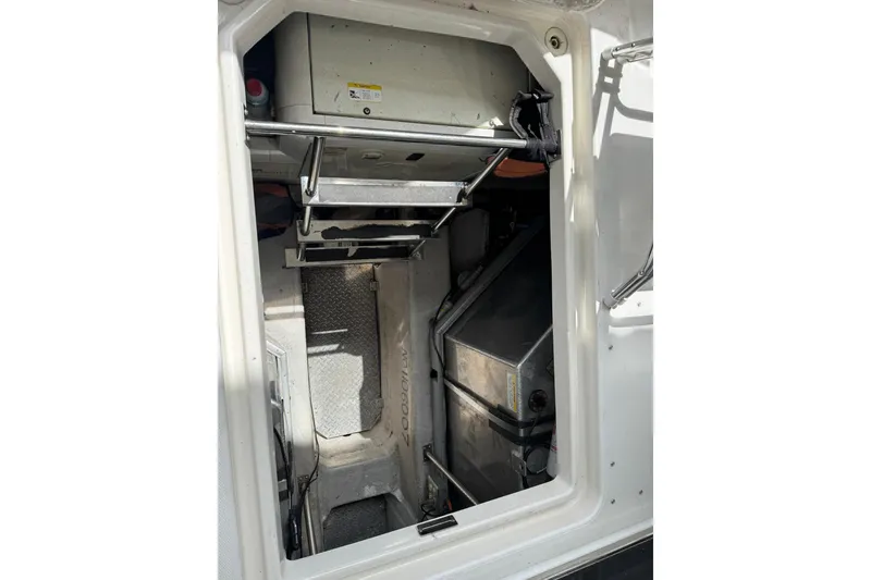 Slide: The Image of Engine room of 1999 Carver 450 Voyager Pilothouse with visible equipment and access ladder. - 62