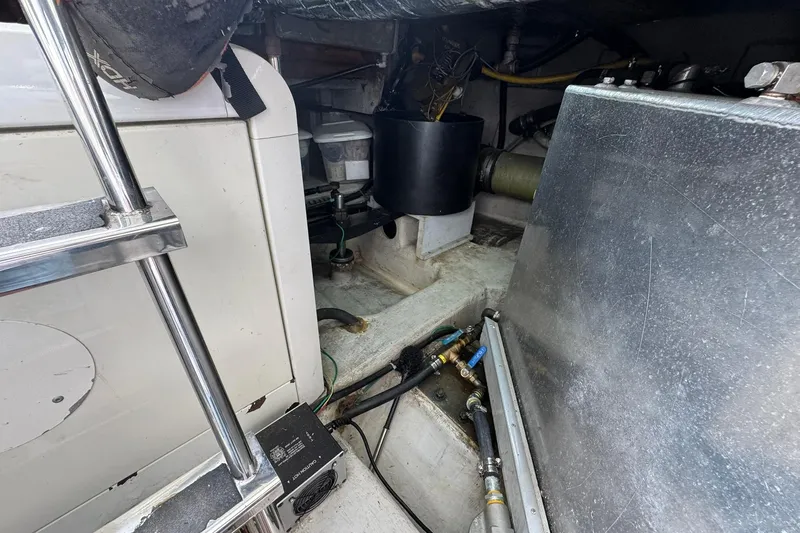 Slide: The Image of Engine room of 1999 Carver 450 Voyager Pilothouse with visible machinery and components. - 63