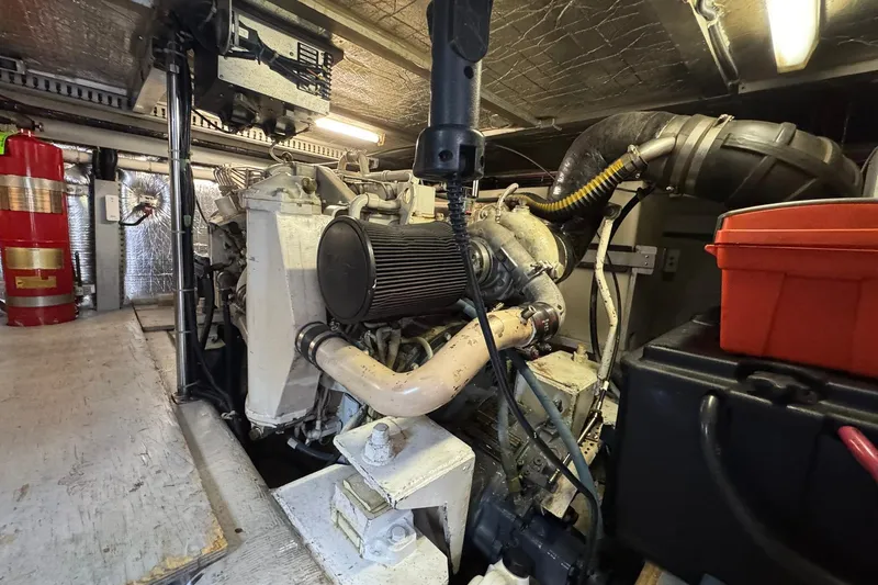 Slide: The Image of Engine room of a 1999 Carver 450 Voyager Pilothouse with visible machinery and equipment. - 68