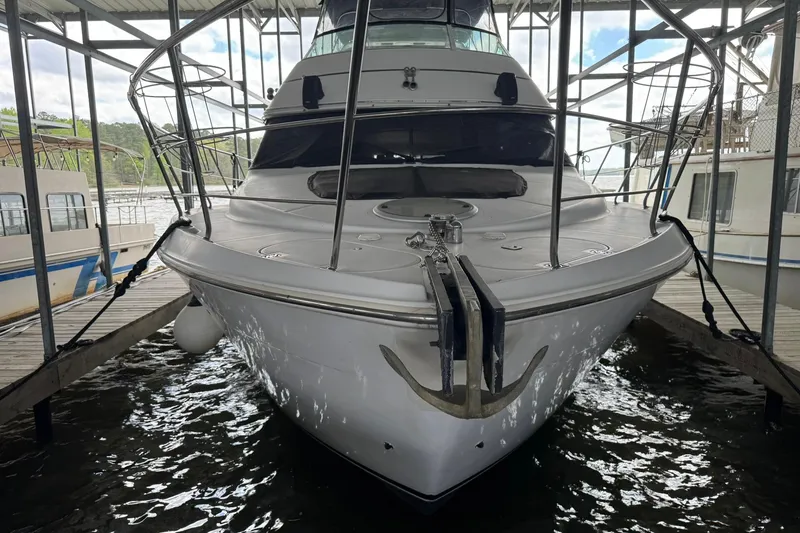 Slide: The Image of 1999 Carver 450 Voyager Pilothouse yacht docked in a marina. - 7