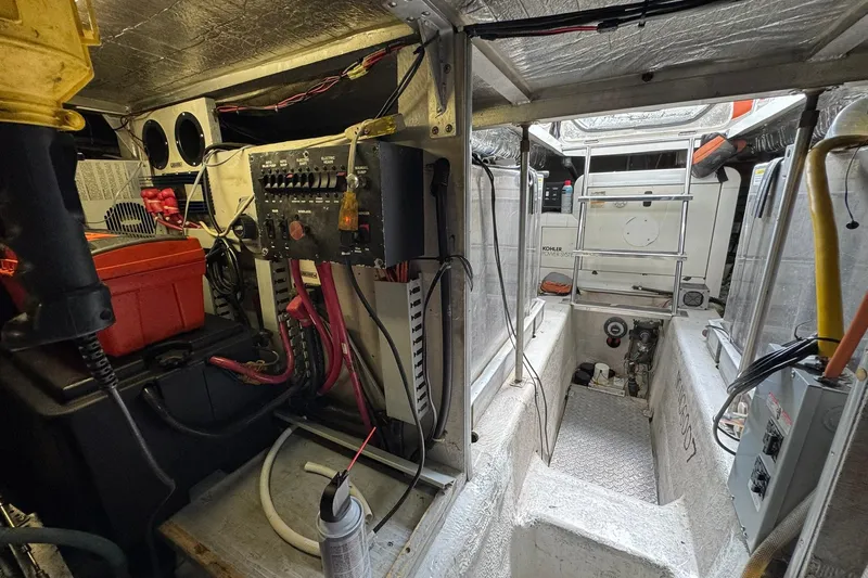Slide: The Image of Engine room of a 1999 Carver 450 Voyager Pilothouse with electrical panels and equipment. - 72