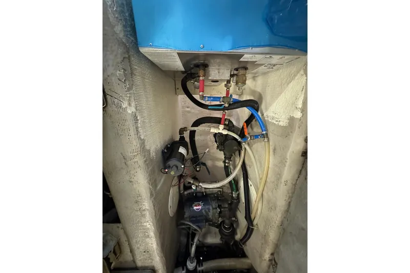 Slide: The Image of Engine compartment of 1999 Carver 450 Voyager Pilothouse with visible wiring and components. - 74