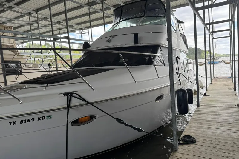 Slide: The Image of 1999 Carver 450 Voyager Pilothouse docked in a covered marina slip. - 8
