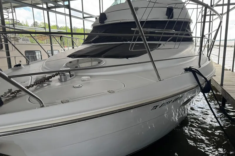 Slide: The Image of 1999 Carver 450 Voyager Pilothouse yacht docked in a marina. - 9