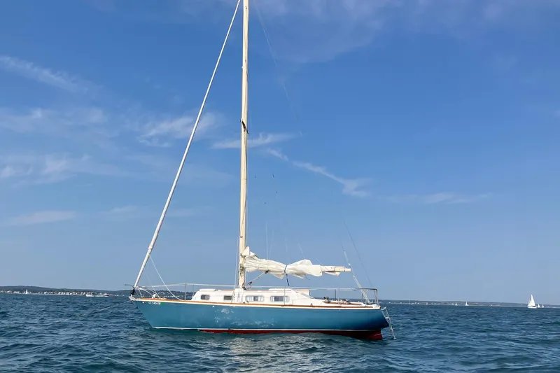 Slide: The Image of 1974 Tartan Sloop sailboat on calm blue waters under clear sky. - 2